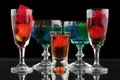 Closeup of some glasses with cocktails of different colors in nightclub