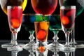 Closeup of some glasses with cocktails of different colors in nightclub