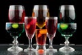 Closeup of some glasses with cocktails of different colors in nightclub