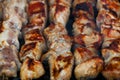 The closeup of some meat skewers being grilled in a barbecue. grilled meat skewers, barbecue Royalty Free Stock Photo