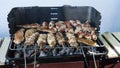 closeup of some meat on Wooden skewers being grilled in a barbecue. Grilling marinated shashlik on a coal grill. Food and Cuisine Royalty Free Stock Photo