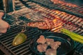 Closeup of someone turning a tasty steak cooking on a fire Royalty Free Stock Photo