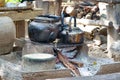 Closeup of sooty kettles over fire on an earth stove Royalty Free Stock Photo