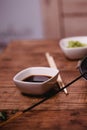 Closeup soy sauce, Sticks, Wasabi and for sushi on brown wooden table background. Top view Royalty Free Stock Photo