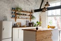 Closeup of a spacious loft industrial open space kitchen studio interior with big windows and sunlight Royalty Free Stock Photo