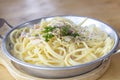 Spaghetti Carbonara in plate on wooden table at the restaurant. Royalty Free Stock Photo