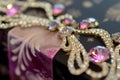 closeup of sparkling gems adorning a ribbon on a luxury gift box