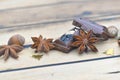 spices and chocolate with nuts and christmas confetti on a wooden table Royalty Free Stock Photo