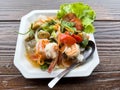 Closeup of the spicy Thai seafood salad served in the white plate Royalty Free Stock Photo