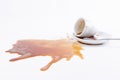 Closeup of a spilled cup of coffee with a saucer isolated on a white background Royalty Free Stock Photo