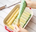 Spinach and cheese cannelloni preparation : Stuffing the cannelloni with the spinach and cheese filling Royalty Free Stock Photo