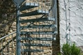 Closeup of spiral metal stairs on a  wall background Royalty Free Stock Photo