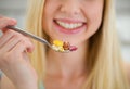 Closeup on spoon with flakes in hand of girl