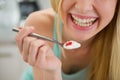 Closeup on spoon with yogurt in hand of girl Royalty Free Stock Photo