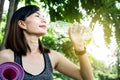 Sport Asian woman drinking water from bottle another hand holding yoga mat Royalty Free Stock Photo