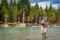 Closeup of a sport fly fisherman hooked into a salmon on a river in British Columbia Royalty Free Stock Photo