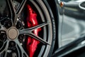 closeup of sports car alloy rim with red brake caliper