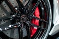 closeup of sports car alloy rim with red brake caliper Royalty Free Stock Photo