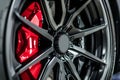 closeup of sports car alloy rim with red brake caliper Royalty Free Stock Photo