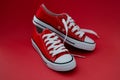 Closeup of sports children sneakers on red background