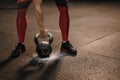 Closeup of sports woman holding kettlebell while crossfit training. Female lifting heavy weights Royalty Free Stock Photo