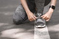 Closeup Of Sporty Female Tying Shoes Before Running Outdoors, Cropped Image Royalty Free Stock Photo