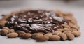 Closeup spreading chocolate over roasted almonds