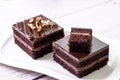 Closeup of square slices of chocolate cake on white ceramic plate