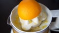 Closeup of a squeezed orange on a juicer