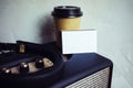 Closeup Stack Blank Business Card Portable Speaker.White Paper Mockup Take Away Coffee Cup Empty Wall Background.Modern