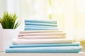 Closeup stack of blue and white clean bedding on the table. Blurred background Royalty Free Stock Photo