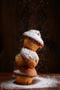 Stack of blueberry muffins with powdered sugar falling Royalty Free Stock Photo