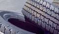 Closeup of Stack of Brand New Automobile Black Tyres with Number