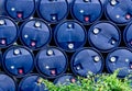 Closeup stack of chemical barrels. Blue oil drum. Plastic oil tank. Toxic waste warehouse. Hazard chemical barrel with warning Royalty Free Stock Photo