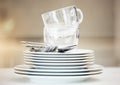 Closeup of a stack of clean dishes. Spotless pile of dishes straight out of the dishwasher. Closeup of a stack of clean
