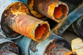 Closeup of Stack of corroded steel pipes with worn insulation industrial background. Rusty waterpipes stacked up Royalty Free Stock Photo