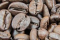 Closeup of stack of dark brown roasted coffee beans