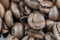 Closeup of stack of dark brown roasted coffee beans