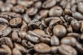 Closeup of stack of dark brown roasted coffee beans