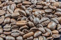 Closeup of stack of dark brown roasted coffee beans