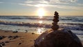 Stack of different stones in balance at the beach sunset Royalty Free Stock Photo