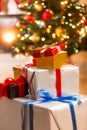 Closeup of stack of gift boxes under Christmas tree at living ro Royalty Free Stock Photo