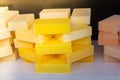 Closeup of a stack of multicolored soap pieces on the shelf