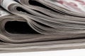 Closeup of stack of newspapers. Assortment of folded newspapers on white. Breaking news, journalism, power of the media,