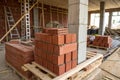 Closeup of stack of red bricks inside building under construction Royalty Free Stock Photo