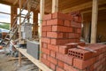 Closeup of stack of red bricks inside building under construction Royalty Free Stock Photo