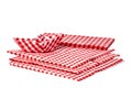Closeup of a stack of red checked paper napkins and a folded paper ship isolated on a white background. Clipping path. Macro. Royalty Free Stock Photo