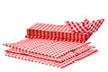 Closeup of a stack of red checked paper napkins and a folded paper ship isolated on a white background. Clipping path. Macro. Royalty Free Stock Photo