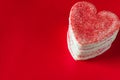 Stacked heart shaped valentines cookies on red background