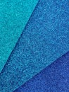 closeup of stacked foamy sheets in metallic blue colors, background and texture